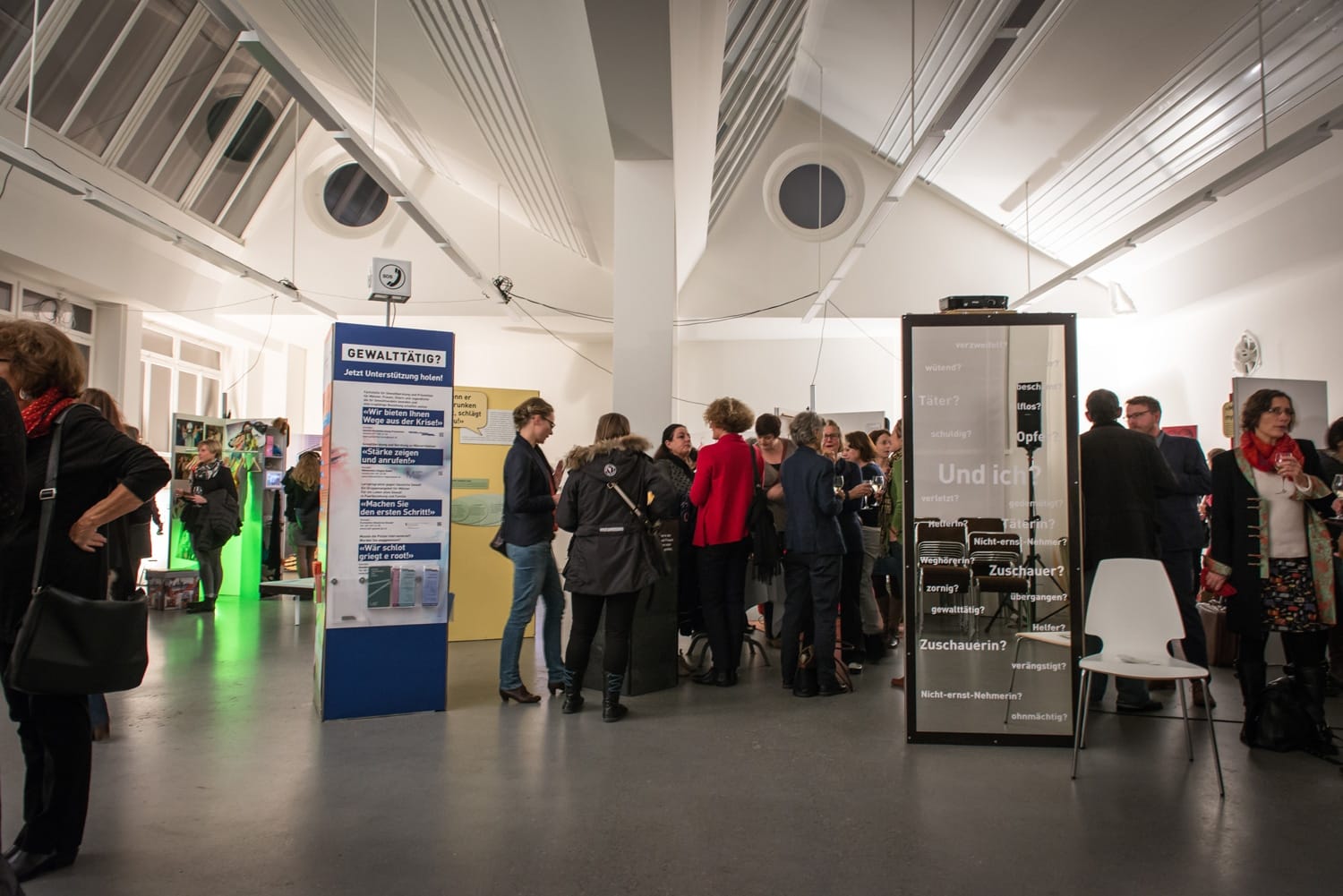 Creatively designed exhibition panels in an old middle-class room with a wooden ceiling.