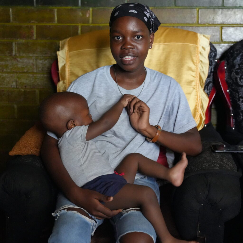 young-mother-with-baby-in-her-arms-on-a-chair-in-the-house